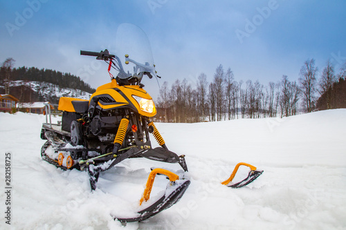Yellow snowmobile closeup. ...