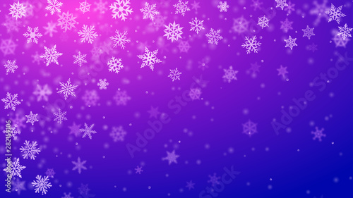 Christmas background of complex blurred and clear falling snowflakes in blue and purple colors with bokeh effect