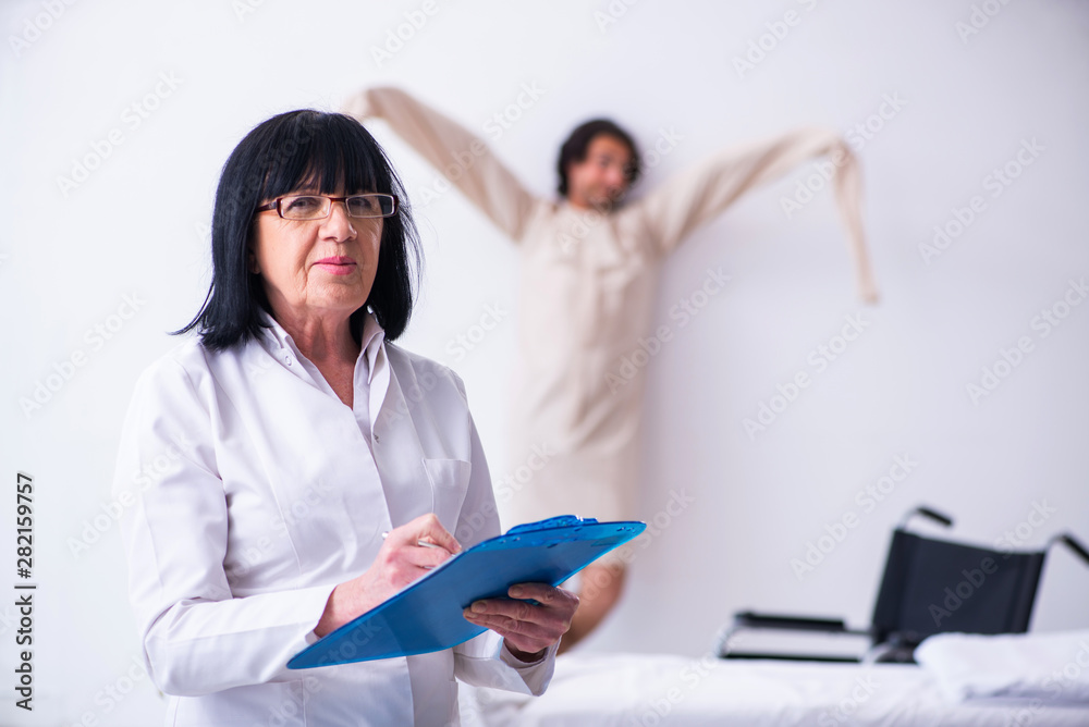 Old female psychiatrist visiting young male patient Old female psychiatrist visiting young male patient
