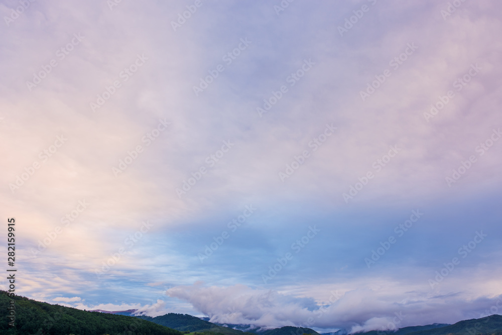 overcast purple sky above the mountain ridge at dawn. beautiful nature background