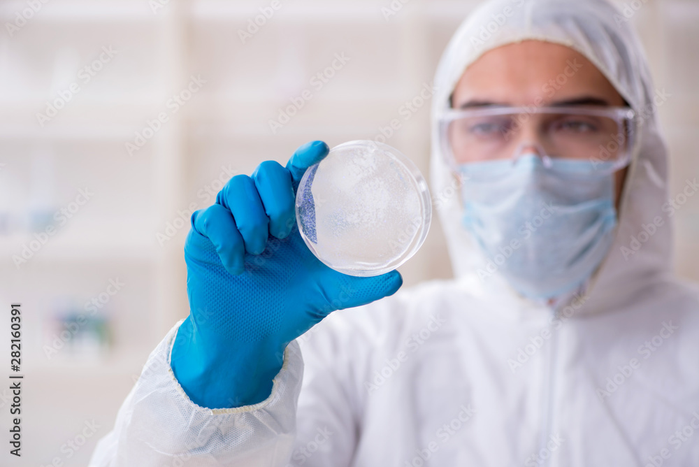 Young male chemist working in the lab Young male chemist working in the lab