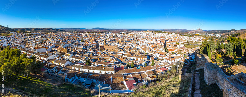 Panoramic aerial skyline view of Antequera city, province of Malaga, Andalusia, Spain. Famous tourist and cultural center. Mountain Pena de los Enamorados (The Lovers Rock) on the right on background
