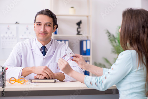 Young woman visiting male doctor oculist