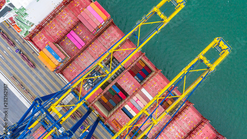 Aerial view cargo ship terminal, Unloading crane of cargo ship terminal, Aerial view industrial port with containers and container ship.