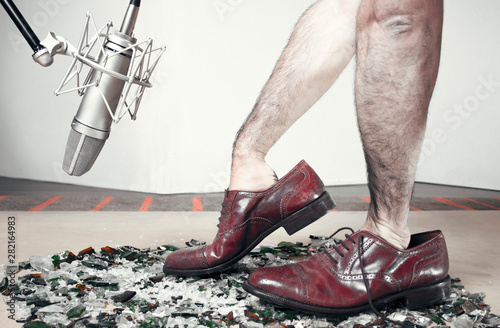 Foley man steps with soundman hands inside the dress shoes. Shoes Color Version photo