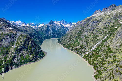 Fototapeta Naklejka Na Ścianę i Meble -  Aerial view over a mountain lake at Grimsel pass in Switzerland