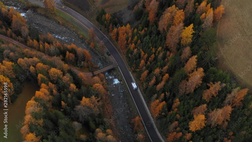 Aerial: RV Drives Down a Picturesque River Road Through Autumnal Pine Forests - South Tyrol, Italy Aerial: RV Drives Down a Picturesque River Road Through Autumnal Pine Forests - South Tyrol, Italy