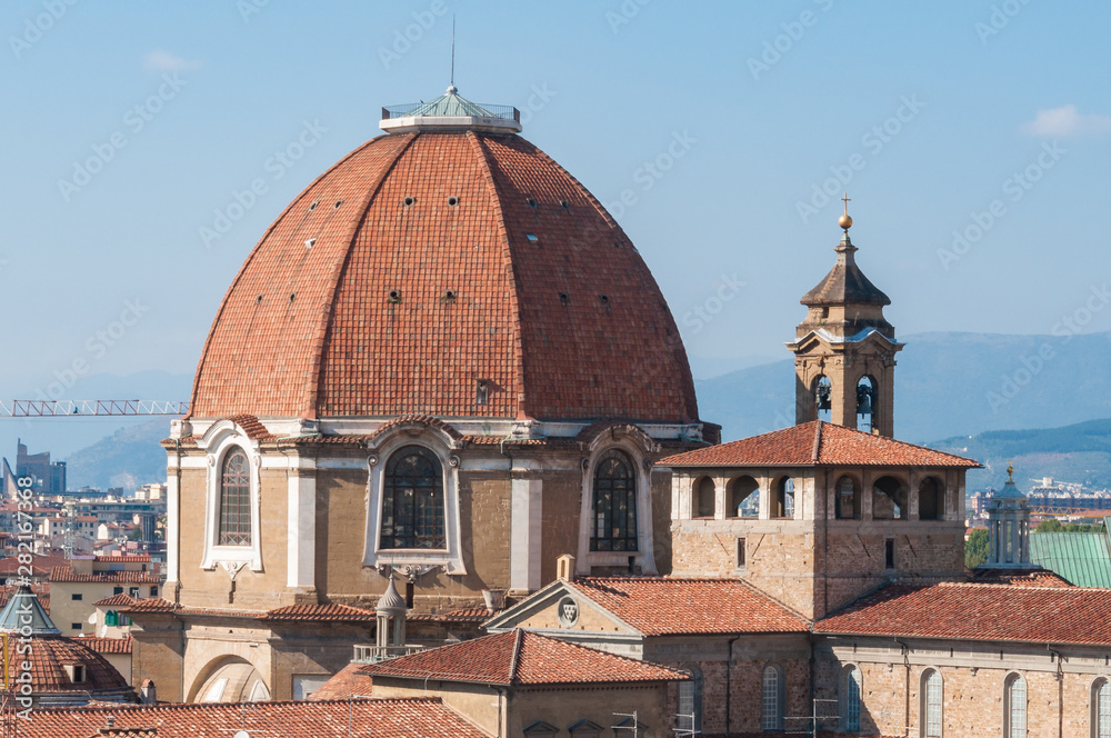 Red-tiles dome and rooftops with dell tower