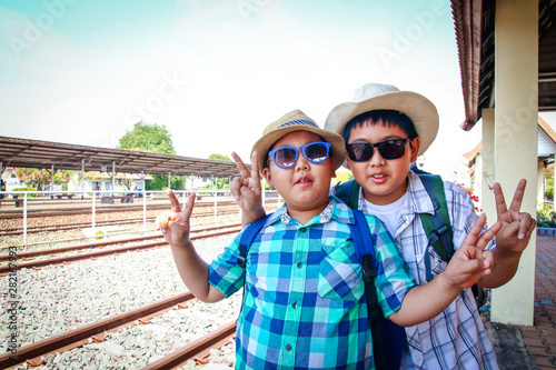 Two Asian boys waiting for the train to travel