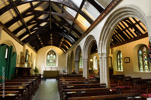 Interior of Anglican St Just's Church with stained glass windows and pipe organ St Just in Roseland Cornwall England