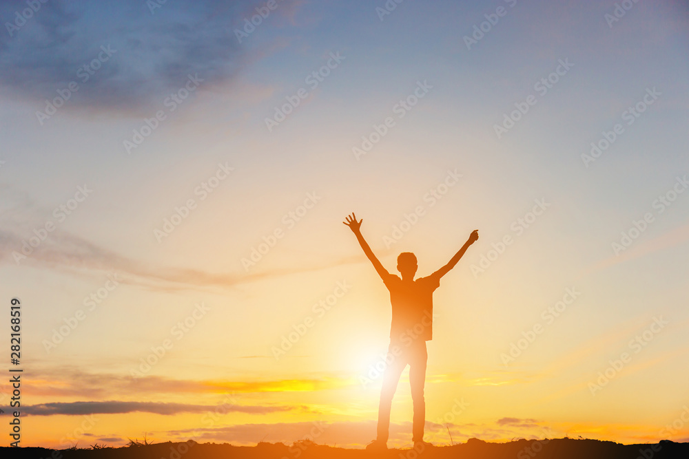 Silhouette of Man Celebration Success Happiness on a mountain top Evening Sky Sunset Background, Sport and active life Concept