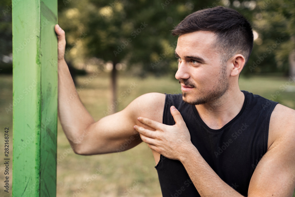 Man stretching arms before workout outdoors Man stretching arms before workout outdoors