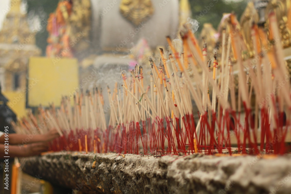 Selective Focus of Worshiping Buddhist worship With incense and candles