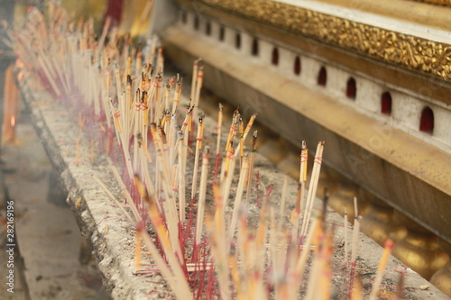 Selective Focus of Worshiping Buddhist worship With incense and candles