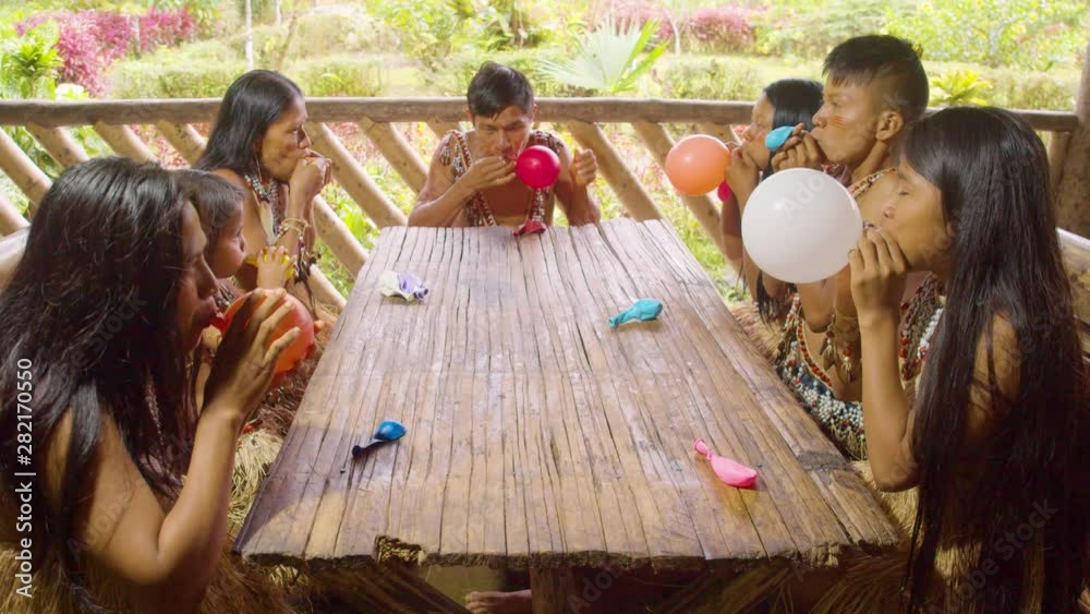 Amazonian Indigenous People Blowing Up Balloons For A Birthday In Ecuador