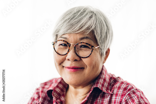 Portrait of happy senior adult elderly asia women smiling and looking at camera on white background.Retirement concept