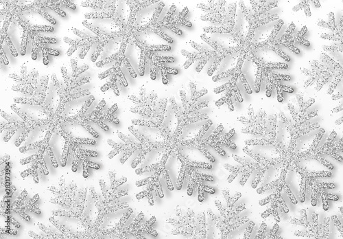 Background silver snowflakes strewn with bright sparkles