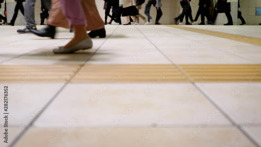 Hundreds of office workers walking past as they exit a busy train station as they rush to their jobs. Hundreds of office workers walking past as they exit a busy train station as they rush to their jobs.