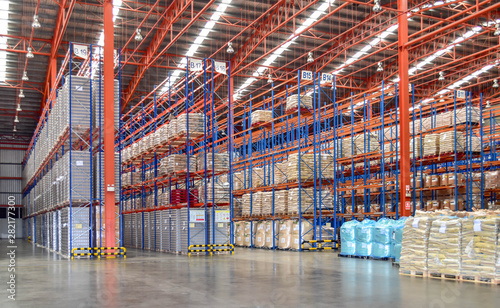 High shelves of cargoes inside large distribution warehouse. Fulfillment center, logistics and supply chains. 