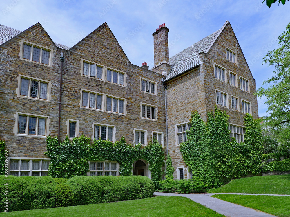 stone gothic style university building with ivy