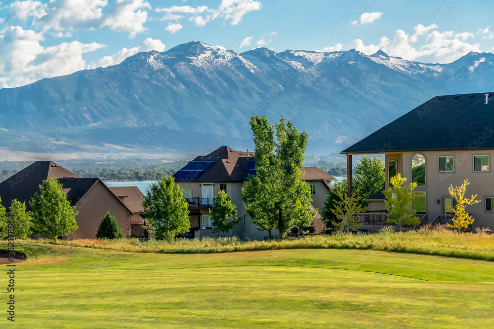 Homes with scenic view of the golf course calm lake and snowy mountain