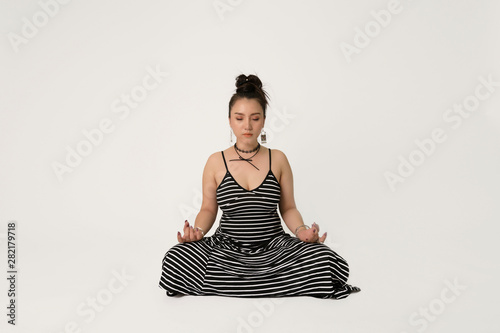 Yoga Woman eye closed mediting indoor on isolated white background photo