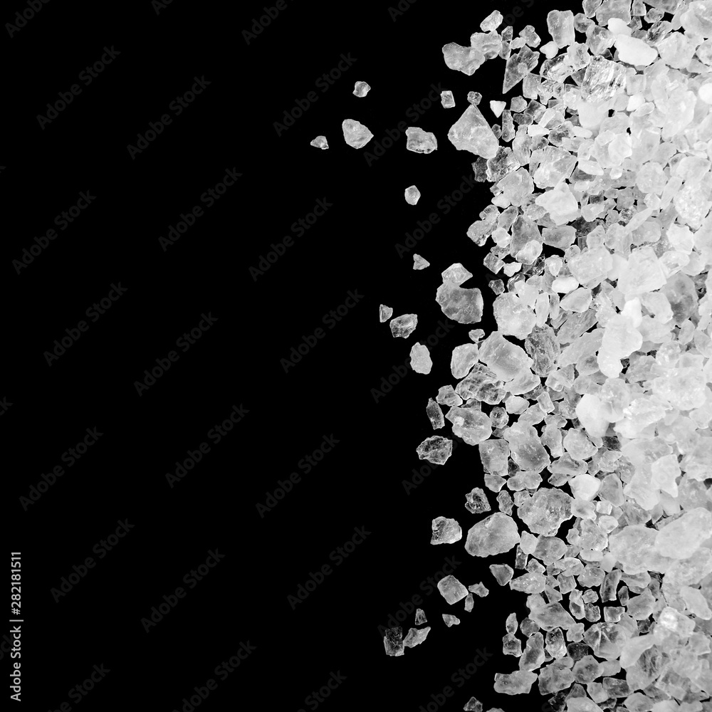A pile of sea salt isolated on black background.
