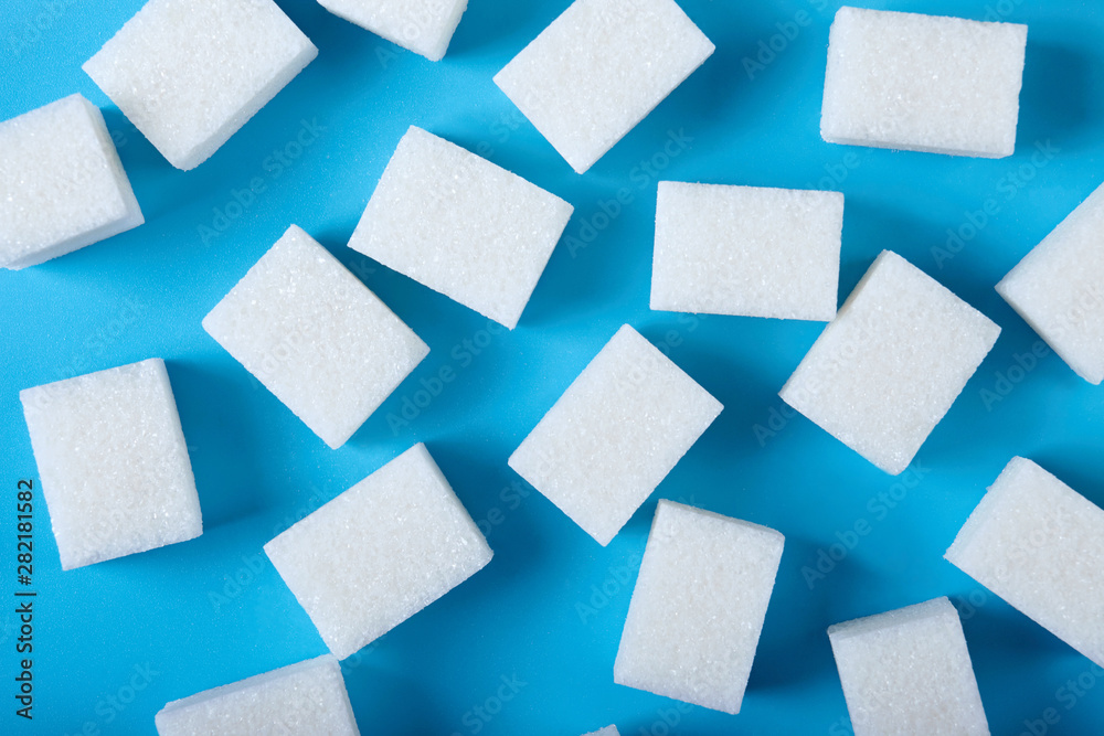 White cubes of shugar on blue background. White cubes of shugar on blue background.