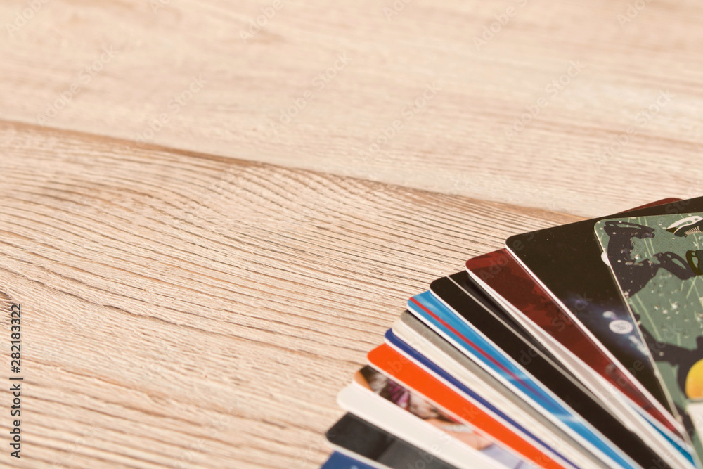Obraz premium Stack of credit cards . Isolated on wooden background. Empty text space.