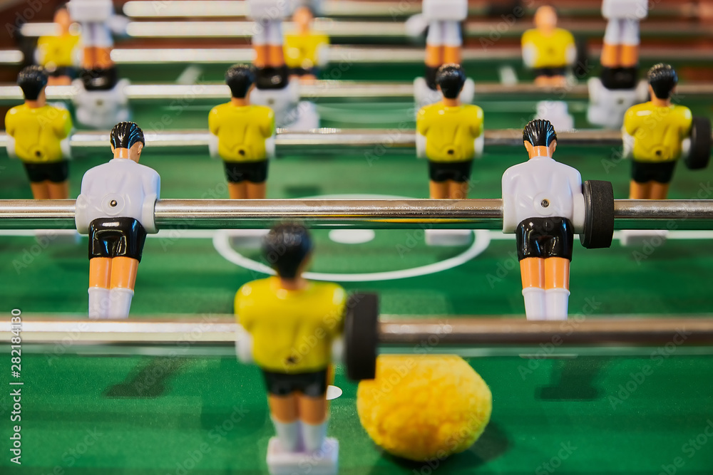 Table football, table football with close-ups of yellow and white players.