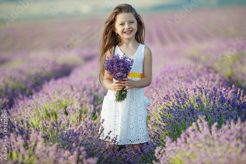 Little girl in a field with lavender.