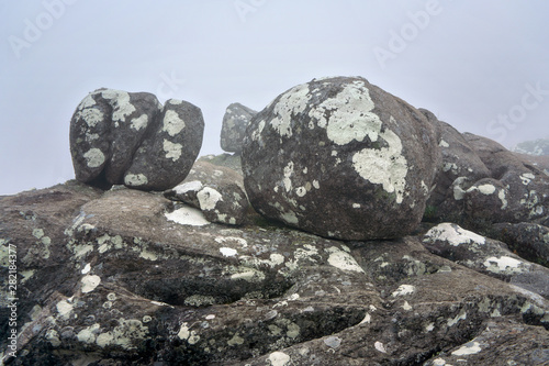 Large boulders covered with lichen spots on foggy morning. Typical scenery during trek to Pic Boby aka Imarivolanitra in Andringitra National Park, highest accessible  peak of Madagascar © Lubo Ivanko