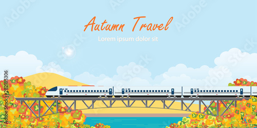 Speed train on railway bridge on colorful autumn trees.