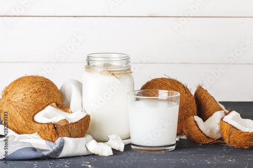 Coconut and  glass of coconut milk on  wooden background