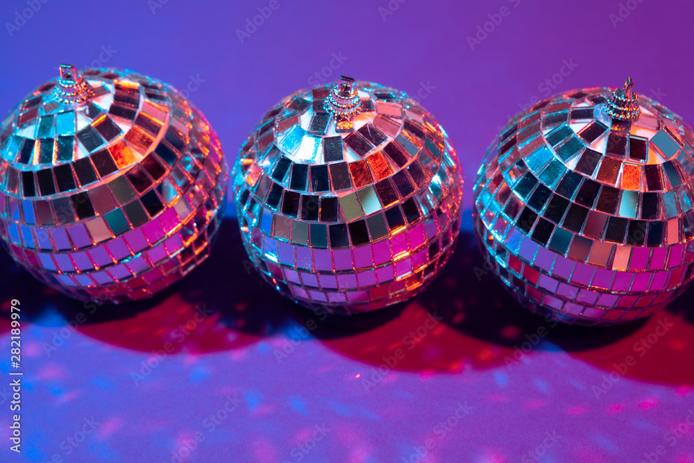 disco ball shines on purple background close up