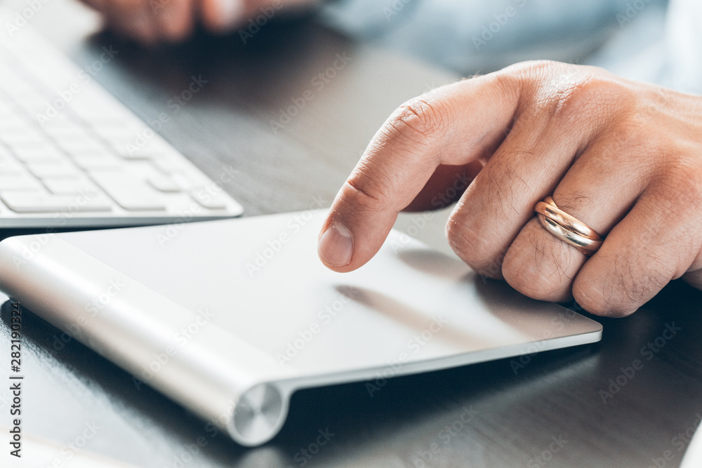 Businessman hand using touch pad of laptop close up Businessman hand using touch pad of laptop close up