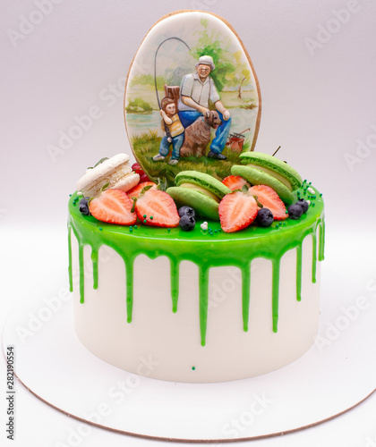 Cake decorated with green chocolate drops, berries, macaroons and gingerbread.