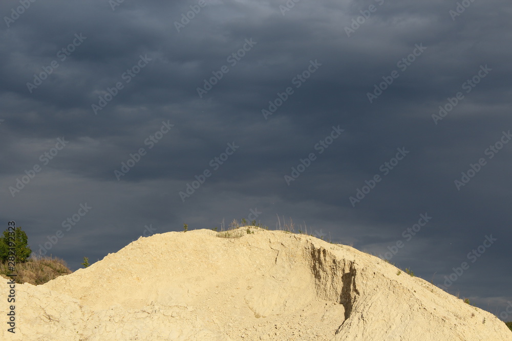 mountain on a quarry and dark clouds