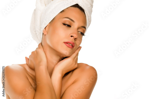 Young beautiful woman with towel on her head on white background