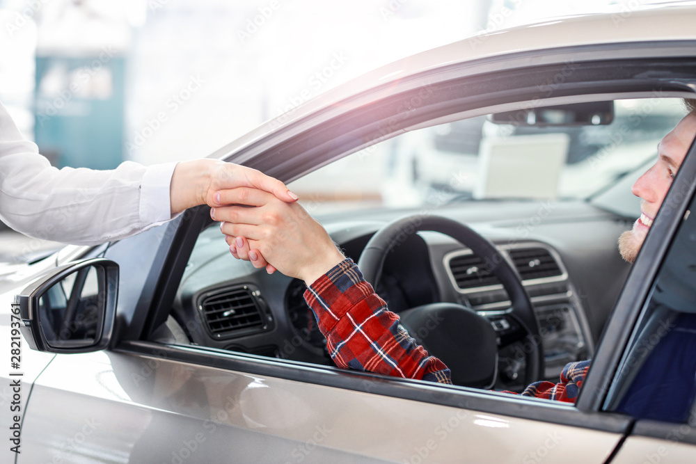 Man buying new car in salon Man buying new car in salon