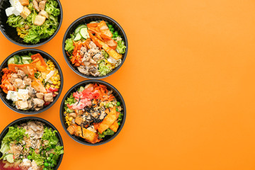 Many containers with delicious food on color background