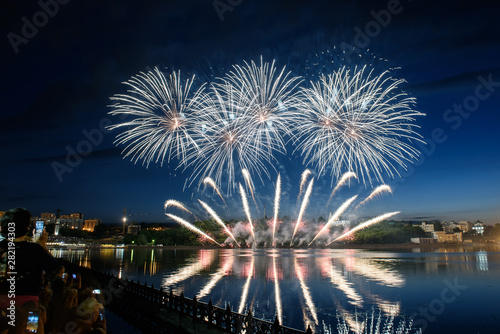 Beautiful pyrotechnic fireworks at night over the water. Celebration. © ksubogdanova