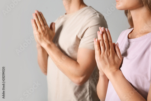 Religious couple praying to...
