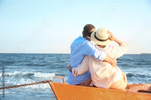 Happy mature couple in boat...