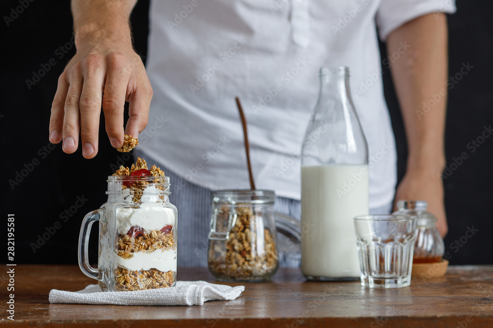 The glass of granola with dried berries and yogurt.
