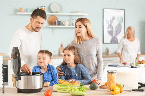 Happy family using modern m...