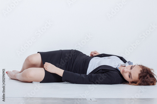 Woman in alcohol intoxication after corporate party eating berry. Pin up female style. Girl wearing unbuttoned business blouse and bra looking seductively with passion.