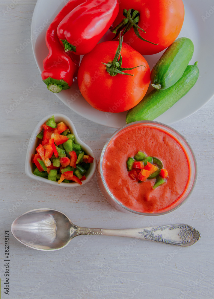 Gazpacho, tomato soup made from made of raw blended vegetables. Traditional Spanish cold soup on wooden table. Gazpacho, tomato soup made from made of raw blended vegetables. Traditional Spanish cold soup on wooden table.