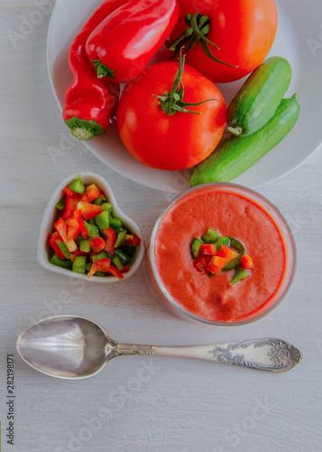 Gazpacho, tomato soup made from made of raw blended vegetables. Traditional Spanish cold soup on wooden table.