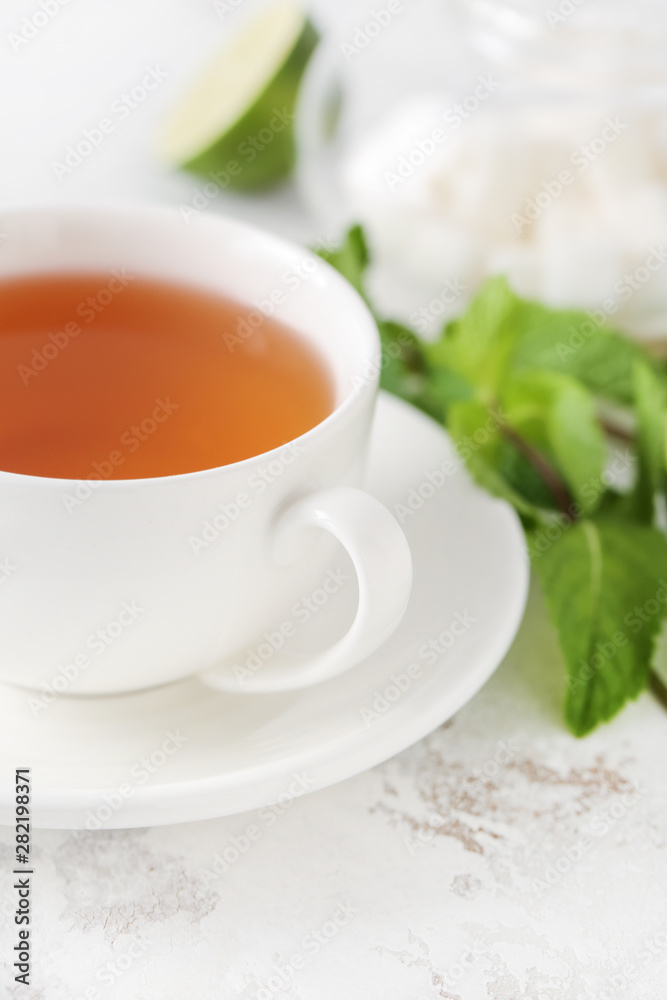 Cup of hot tea on table